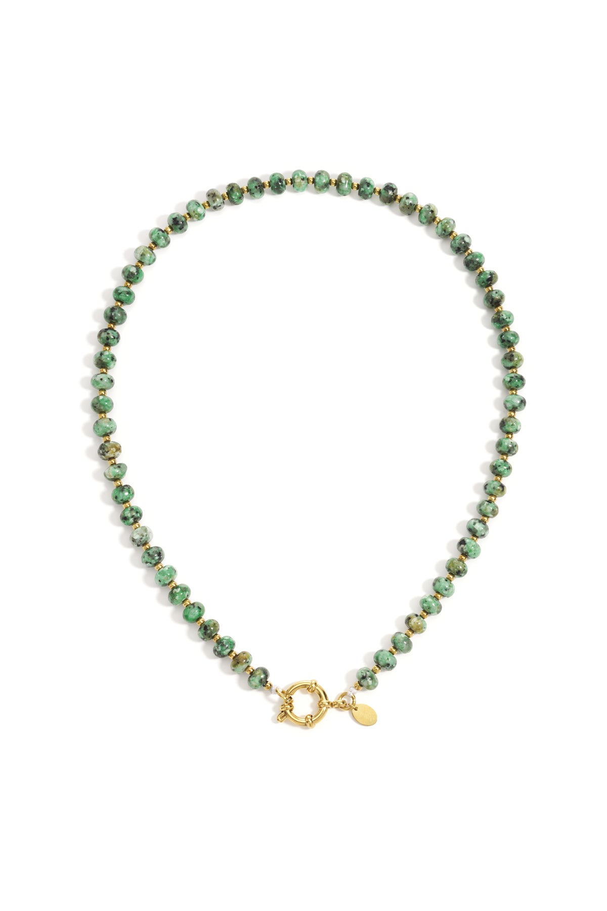Close-up of a green stone beaded necklace with gold beads and toggle clasp