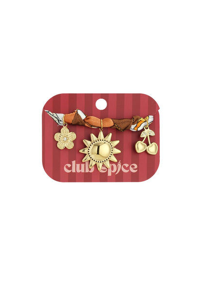 Golden Summer Sun bracelet on display, featuring a twisted patterned fabric band with sun, flower, and cherry gold charms.