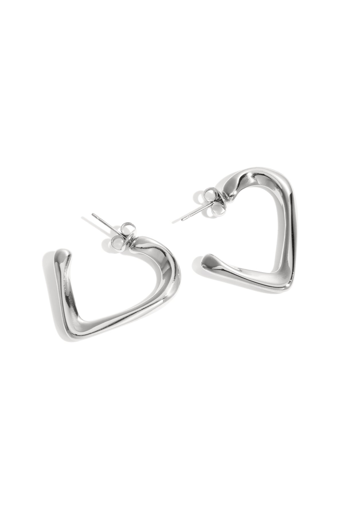 Pair of silver heart-shaped hoop earrings with smooth polished finish on white background
