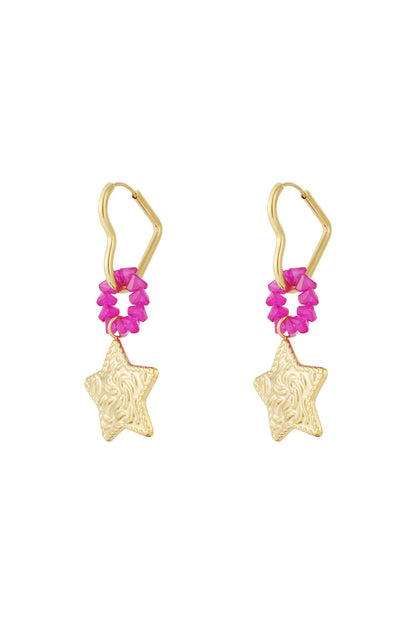 Pair of gold star drop earrings with textured star charms and bright pink beaded rings on unique gold hoops, isolated on white background