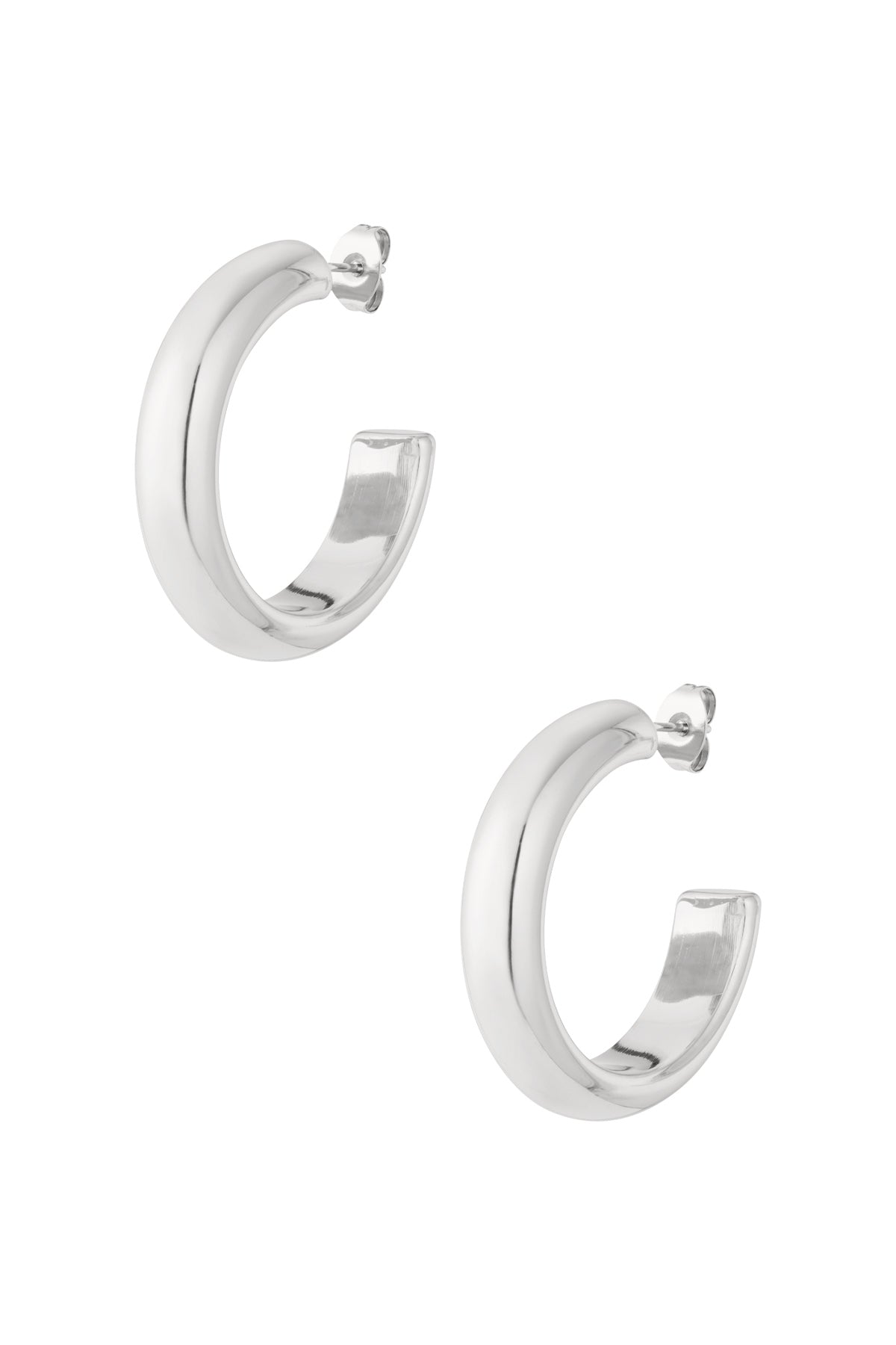 Pair of chunky silver-tone hoop earrings with rounded shape on white background