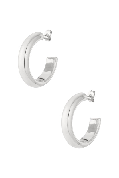 Pair of chunky silver-tone hoop earrings with rounded shape on white background