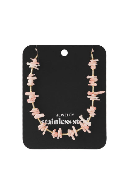 Pink coral chip necklace featuring irregular pastel pink coral beads alternating with thin gold-tone stainless steel tubes.