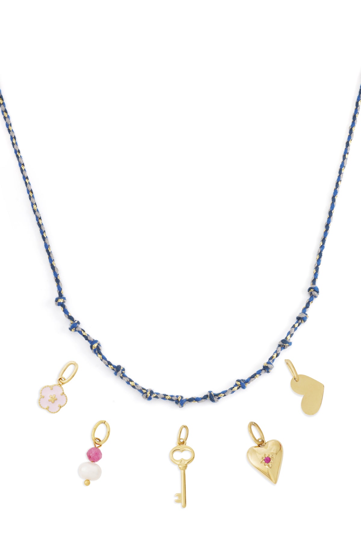 Blue knotted cotton necklace with gold charms including heart, key, pearl and flower charms laid flat on white background