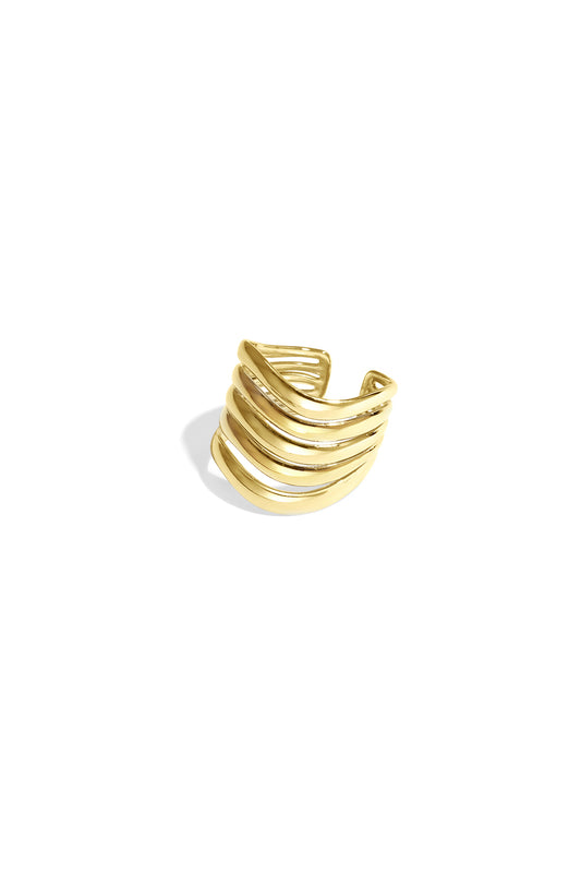 Close-up of a gold wavy layered statement ring with five curved bands on a white background