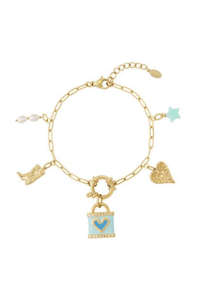 Gold charm bracelet worn with all light blue, pearl, star, boot, and heart charms attached in a circle on white background