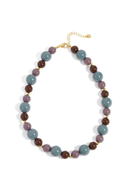 Chunky beaded necklace with burnt orange, chocolate brown, and gold beads on white background