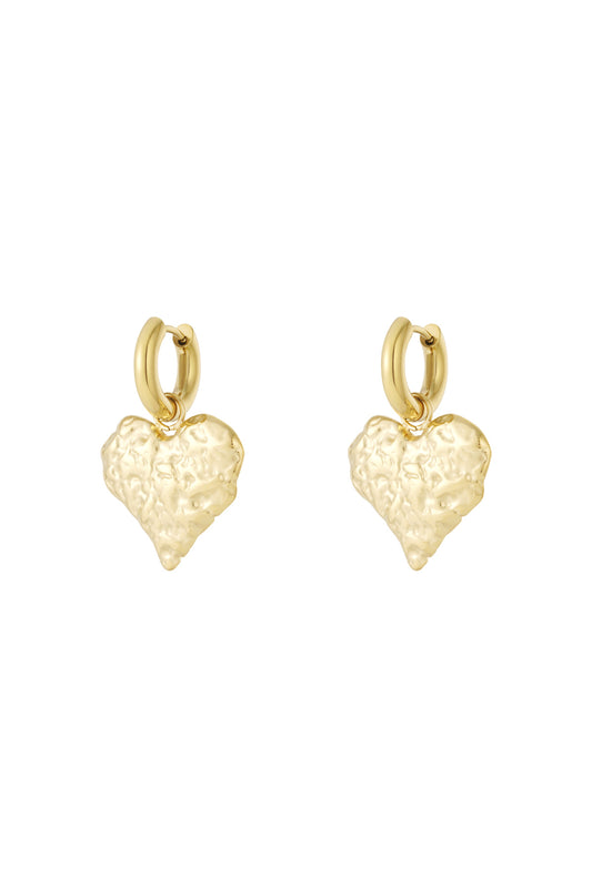 Pair of gold textured heart hoop earrings with hammered finish on white background
