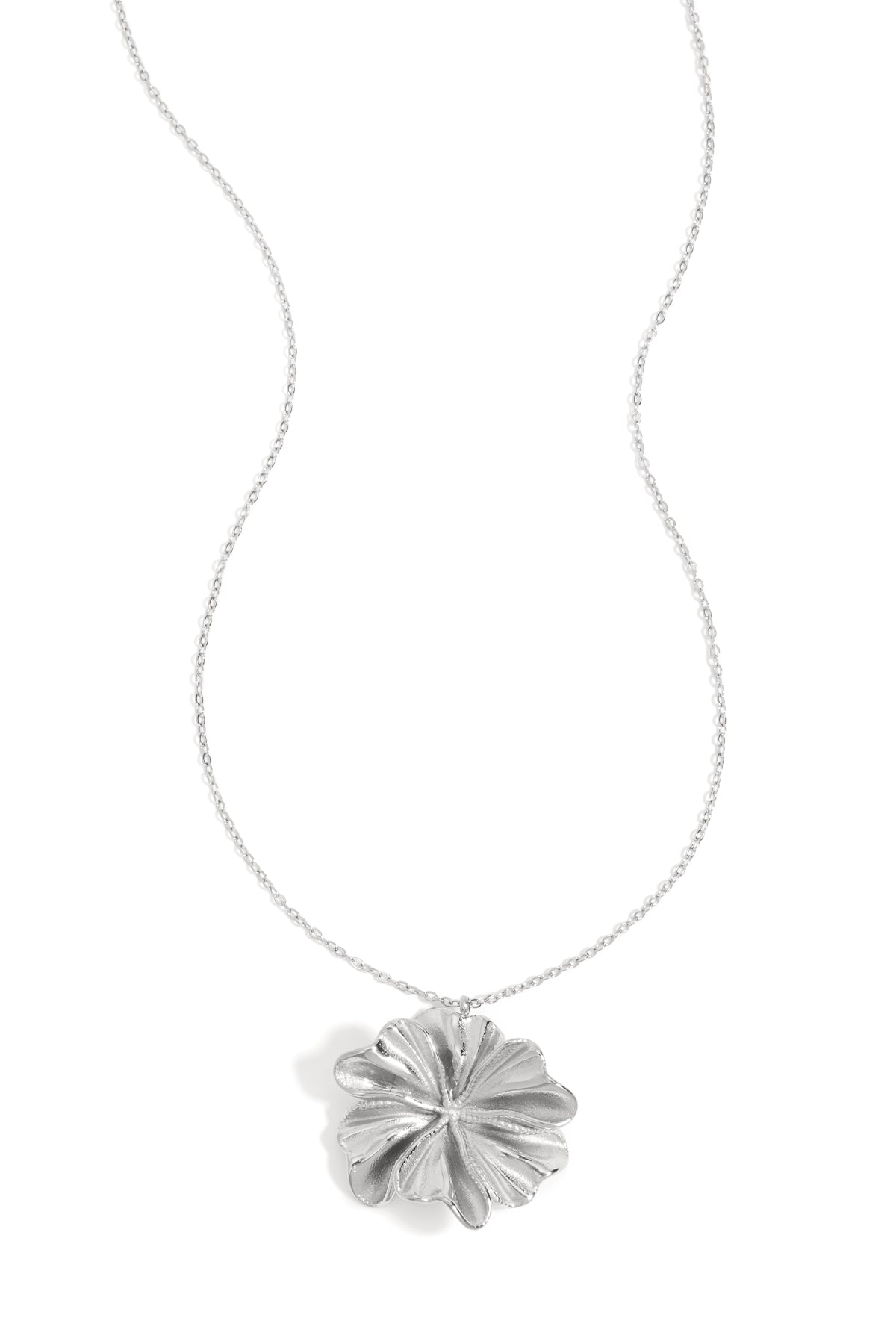 Silver flower-shaped pendant necklace with delicate chain on white background