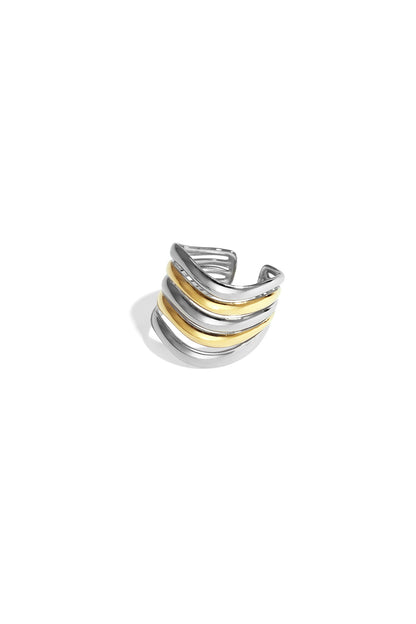 Close-up of a bi-color gold and silver wavy layered statement ring with five curved bands on a white background