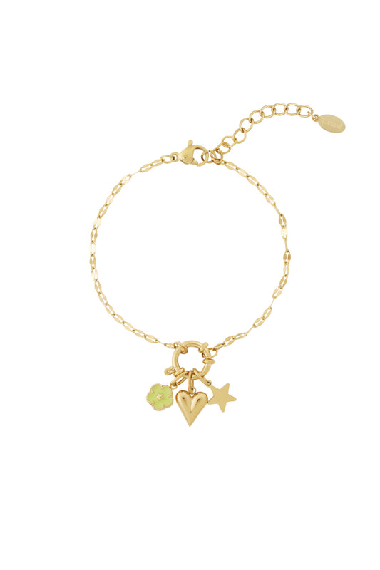 Gold chain bracelet worn with flower, heart, and star charms attached highlighting an adjustable lobster clasp closure