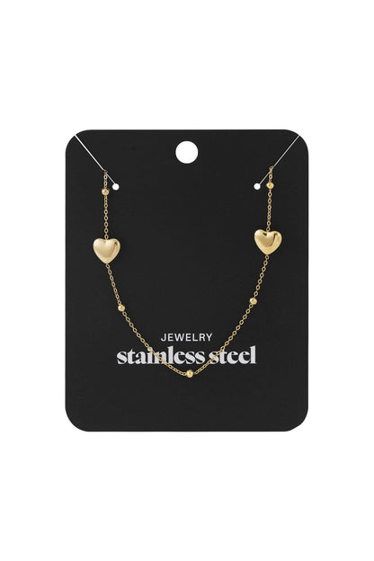 Gold-tone stainless steel Love Struck chain necklace featuring two small heart charms and delicate accent beads.