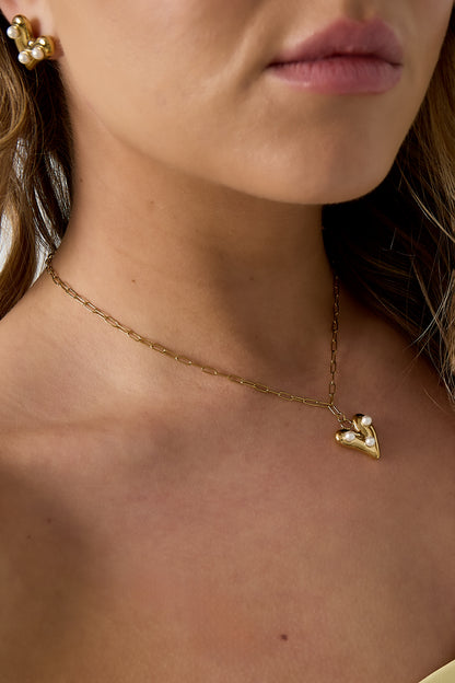 Detailed view of the pearl heart pendant necklace on the model showing the elegant fit and pendant design