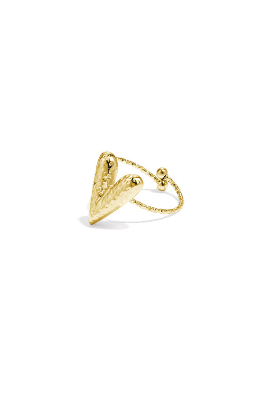 Close-up of a hammered gold-tone heart-shaped statement ring with an adjustable textured band