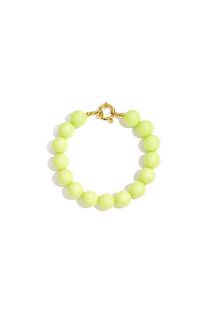 Light green resin bead bracelet with gold toggle clasp on white background
