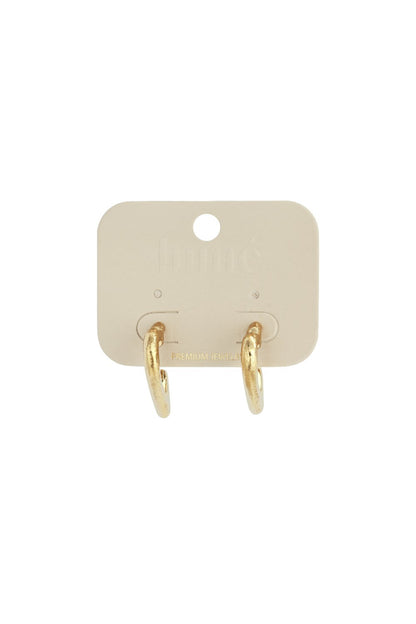 Gold puffy heart-shaped hoop earrings on a light beige display card.