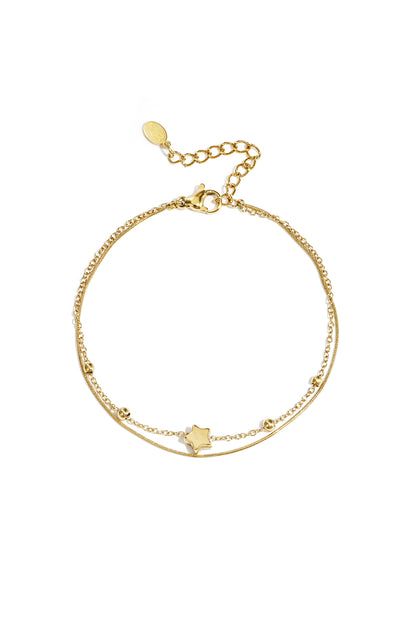 Gold-tone delicate double chain bracelet with star charm, laid flat on a white background showing lobster clasp and extension chain.