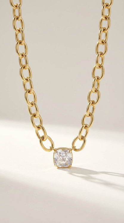 Retro Vibe Pendant: A gold chain necklace with a chunky, oval-link design and a single square-cut crystal pendant.