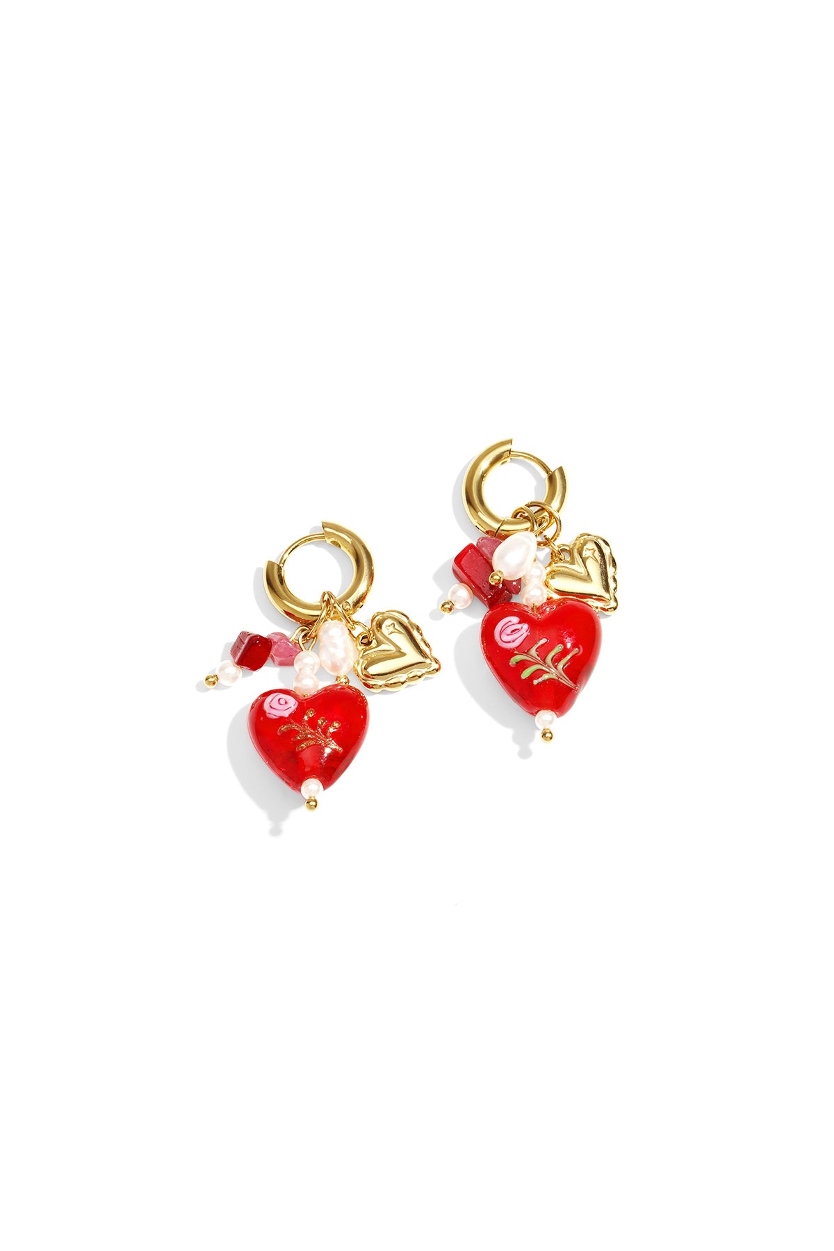 Pair of gold hoop earrings with red heart-shaped charms, floral detailing, and pearl accents on white background