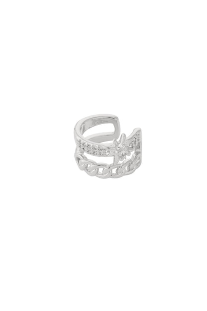 Close-up of silver star and chain link women's ear cuff with zircon stones on white background