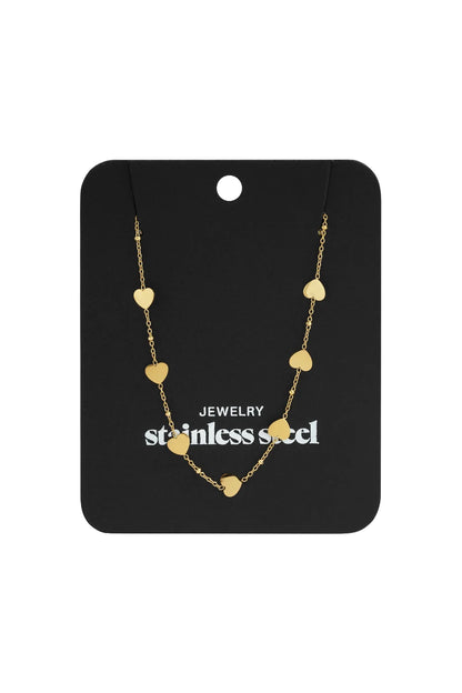 Gold-tone stainless steel chain necklace featuring dainty heart charms and small beads, displayed on a black card.
