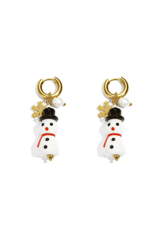 Pair of gold-tone hoop drop earrings with dangling white resin snowman charms wearing black hats and red scarves, accented with gold snowflake and faux pearl.