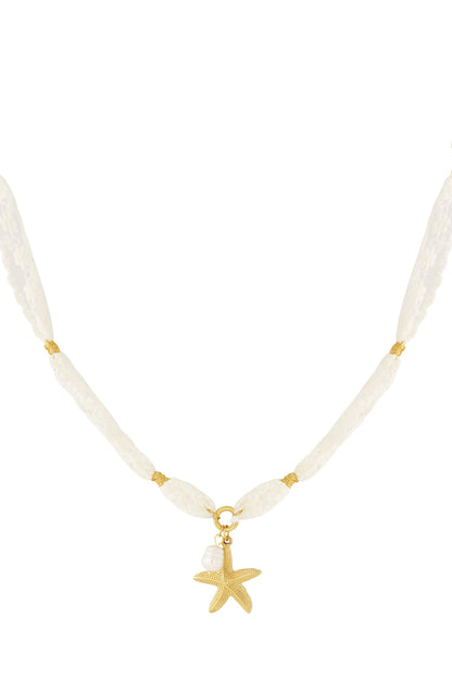Cream lace necklace with gold-tone starfish and pearl charm on white background