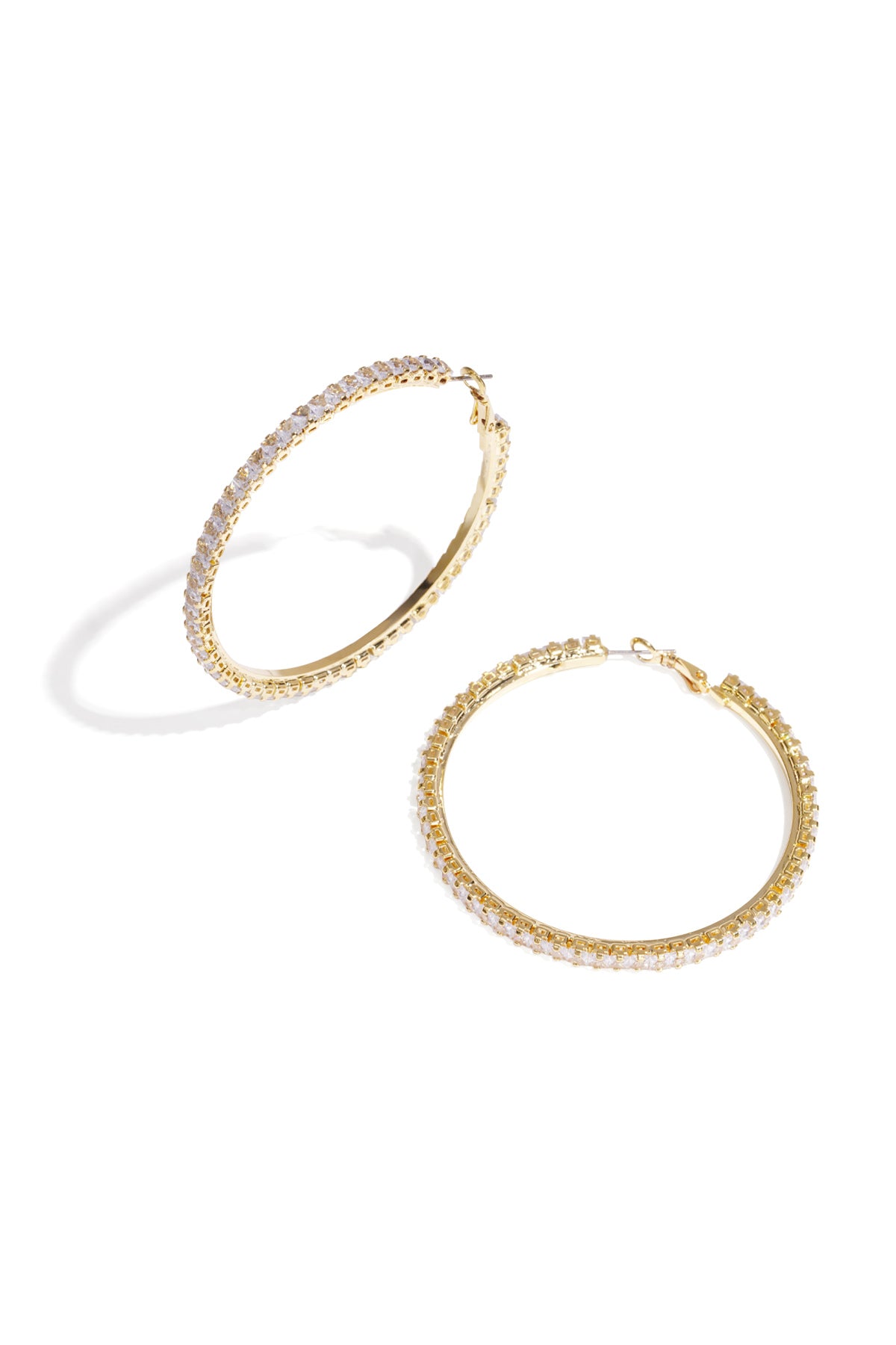 Pair of gold-tone hoop earrings adorned with sparkling clear crystals on white background