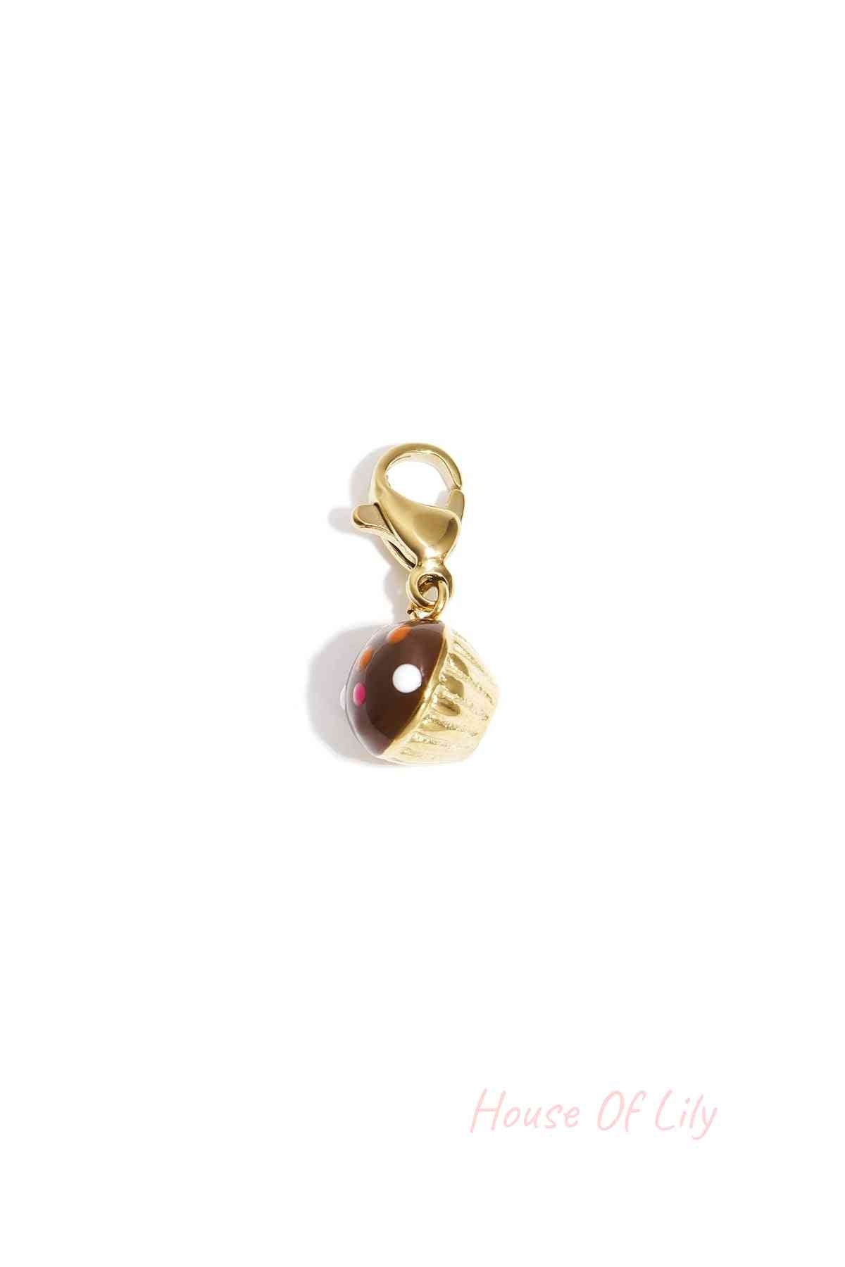 Gold-tone cupcake charm with chocolate-colored enamel frosting and colorful dot accents on a lobster clasp