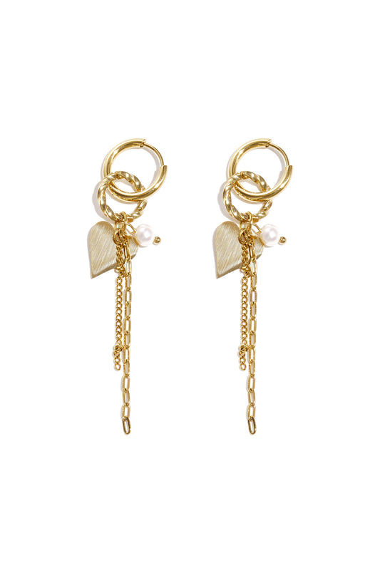 Pair of gold dangle hoop earrings with heart charms, pearls, and chain details against a white background