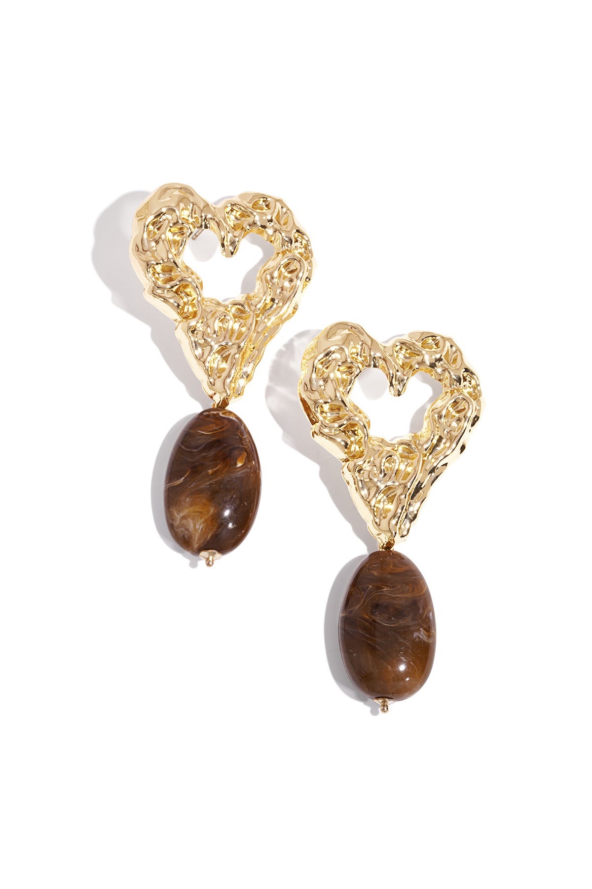 Pair of gold-tone textured heart earrings with warm brown marbled resin drop pendants on white background