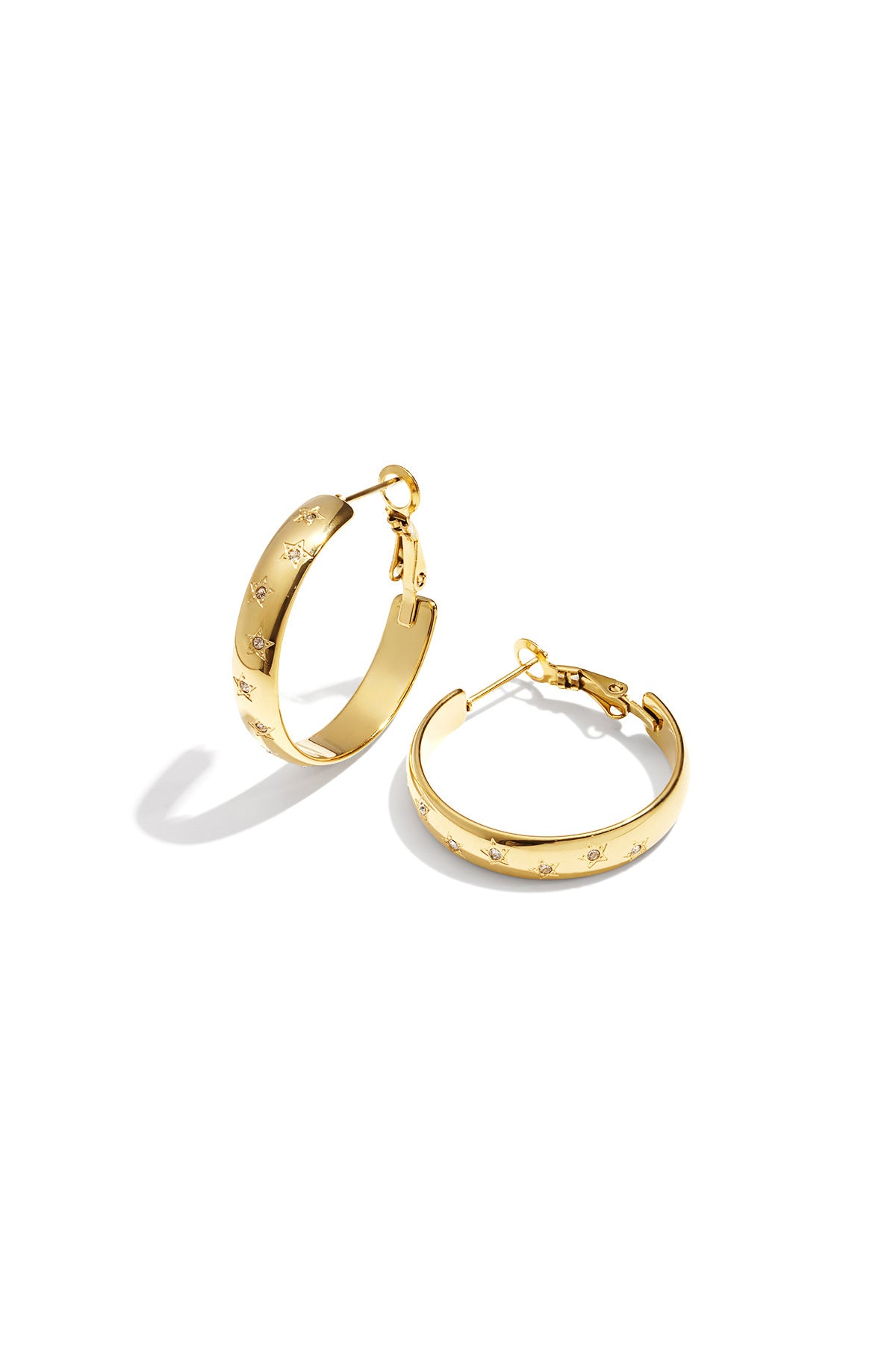 Gold star-embellished hoop earrings with rhinestone accents on white background