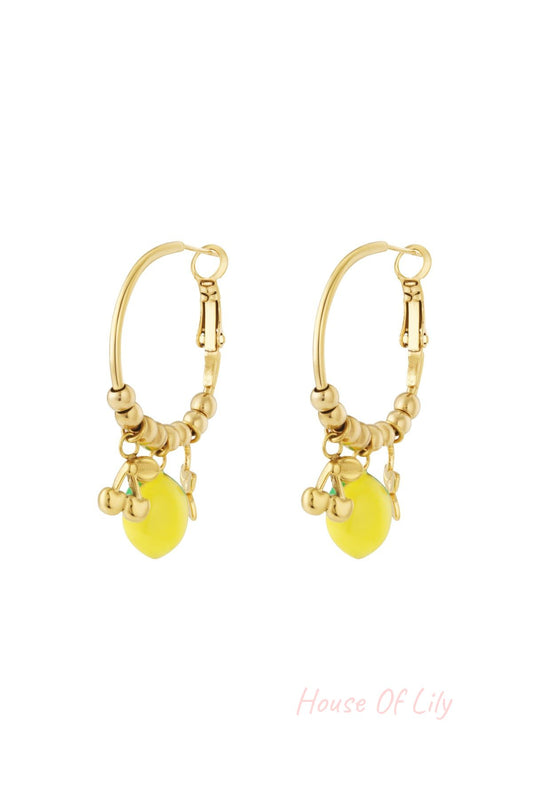 Pair of gold-tone hoop earrings adorned with beaded detail and colorful enamel fruit charms including a lemon and cherries on a white background