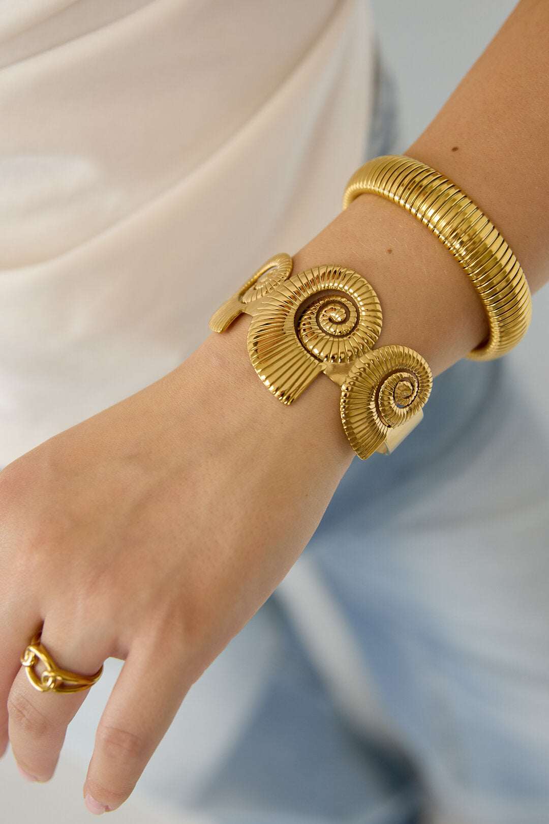 Cuff statement bracelet with spiral shells