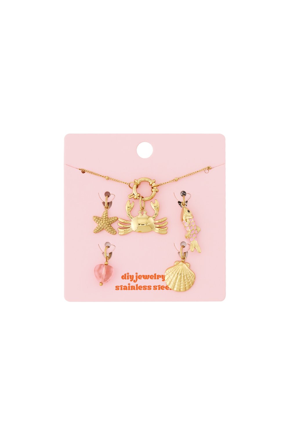 Gold stainless steel charm bracelet kit with crab, starfish, fish, shell, and heart charms on a pink display card.