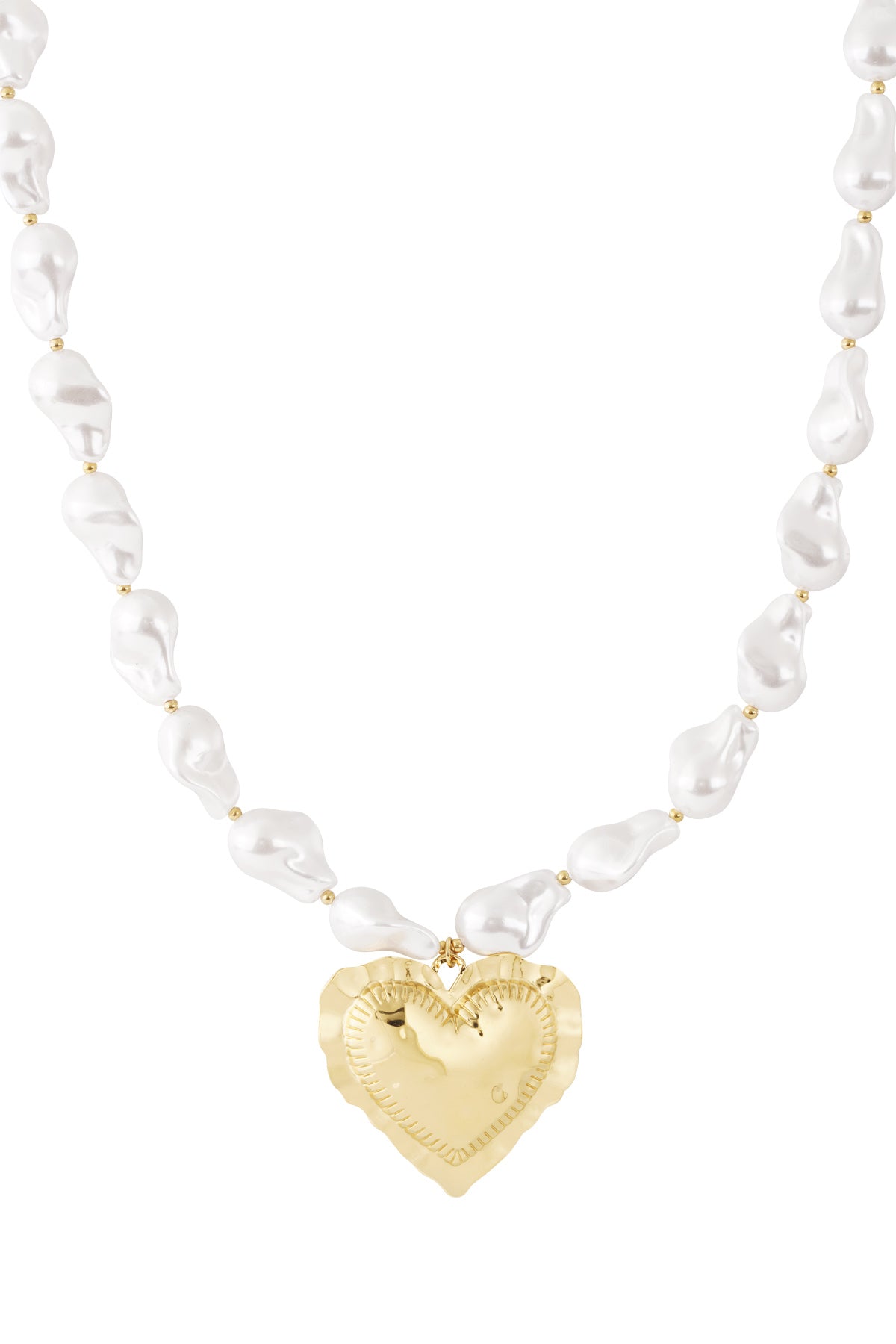 Close-up of a baroque pearl necklace featuring irregular white pearls and a hammered gold heart pendant