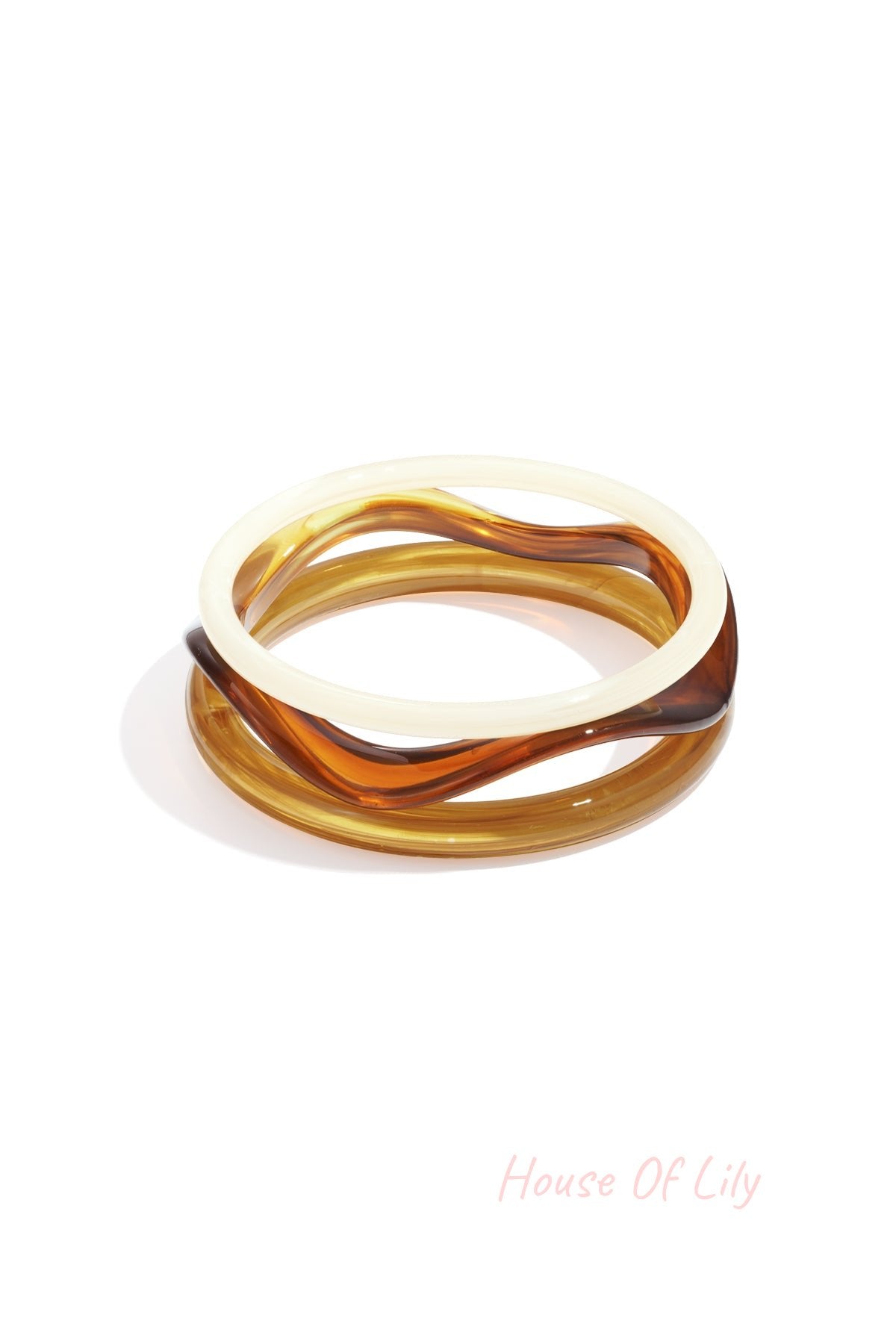 Set of three wave-shaped acrylic bangles in blue, green, and yellow shades on white background