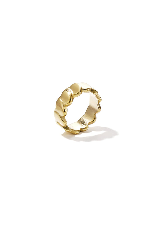 Close-up of a gold chain ring made of linked smooth heart shapes on white background