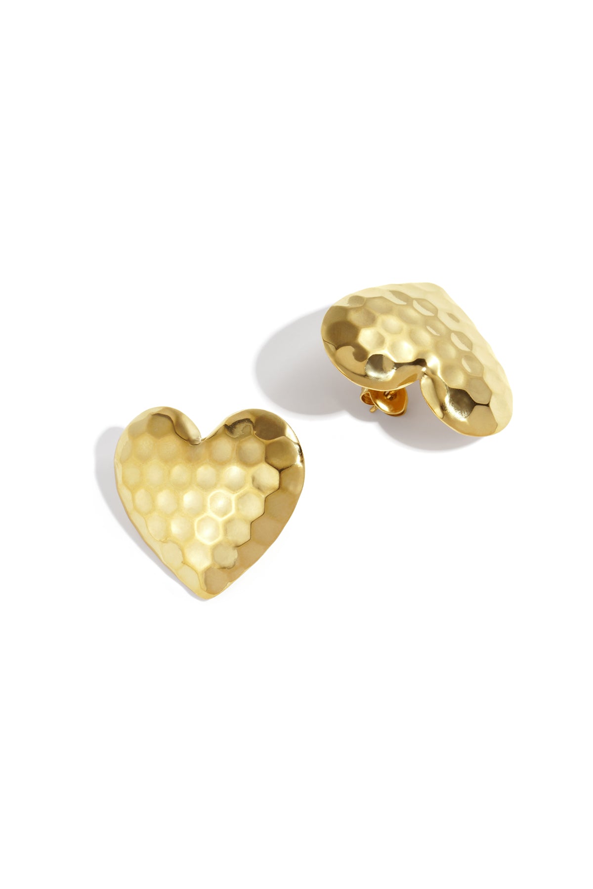 Gold hammered heart-shaped stud earrings with smooth textured surface