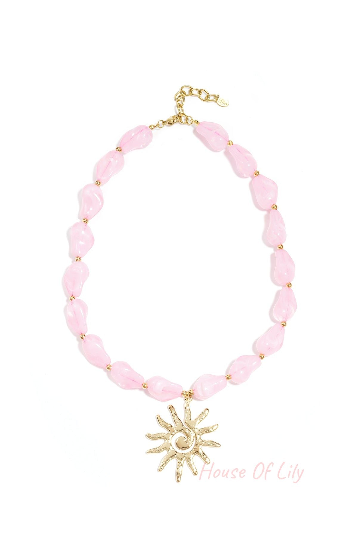 Soft pink acrylic beaded necklace with gold sun pendant displayed on a white background
