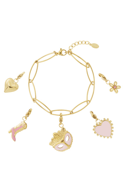 Gold chain charm bracelet laid flat with five gold-plated charms including pink heart, flower, cowboy boot, and mask