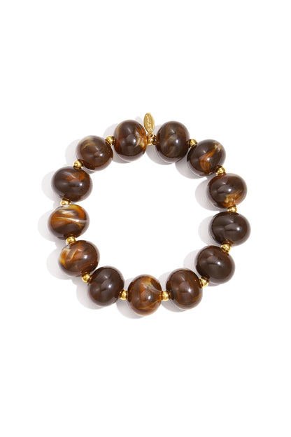 Dark brown marbled beaded stretch bracelet with gold accent beads on white background