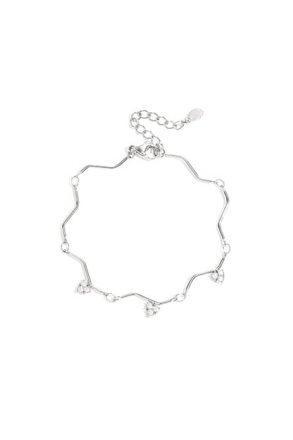 Silver zigzag charm bracelet with heart-shaped rhinestone charms displayed on white background