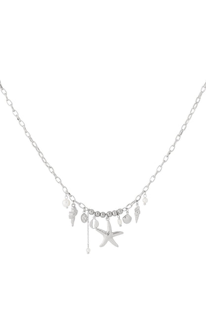 Silver-tone seaside charm necklace with starfish, shells, and pearl charms on delicate oval chain