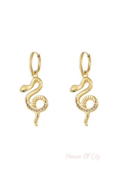 Pair of gold snake charm hoop earrings with rhinestone accents on a white background.