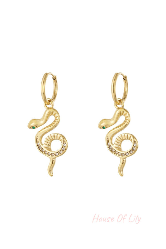 Pair of gold snake charm hoop earrings with rhinestone accents on a white background.