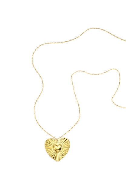 Gold heart pendant necklace with sunburst design on medium gold chain displayed on white background