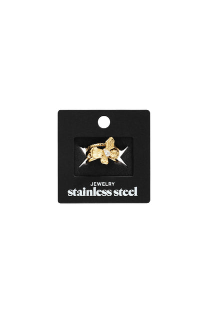 Gold-tone stainless steel ring featuring a flower accent with a central clear stone, displayed on a black backing card.