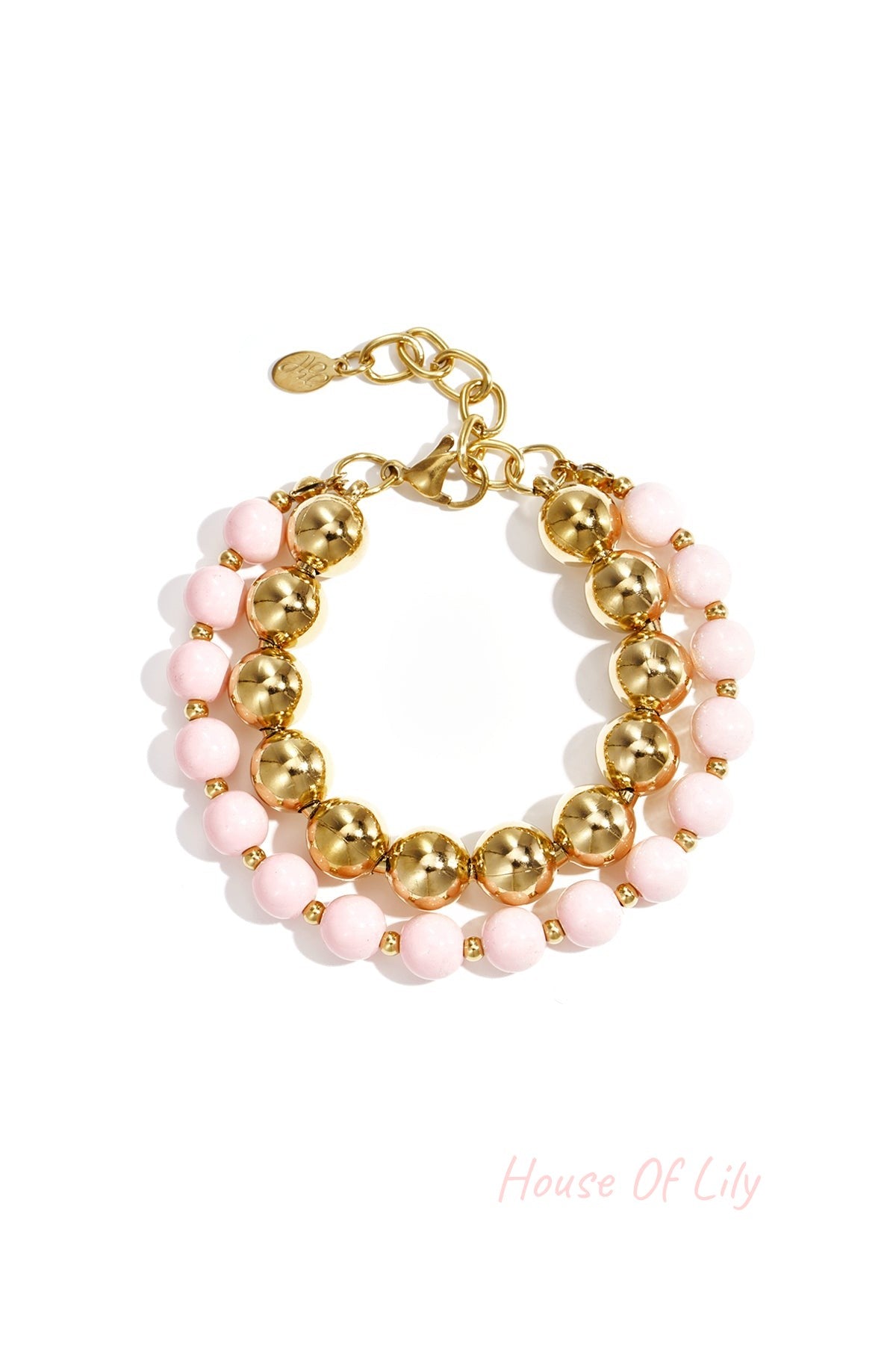 Double layered bracelet with soft pink acrylic and gold-tone beads on white background