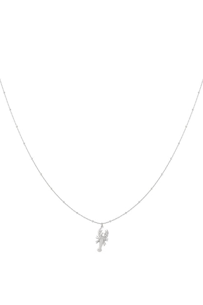 Silver delicate lobster pendant necklace on a thin beaded chain isolated on white background